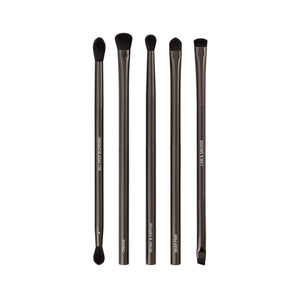 Makeup brush set with six dark bristles and sleek gray metallic handles, upright.