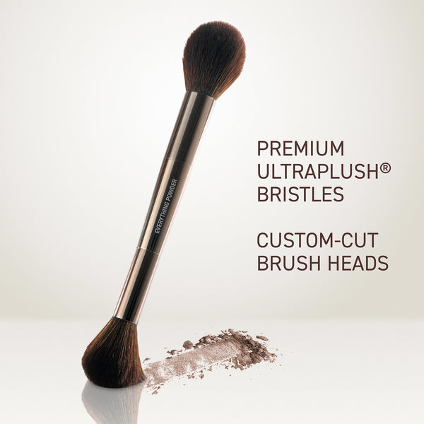 Powder brush angled view with dense black bristles and metallic rose-gold handle